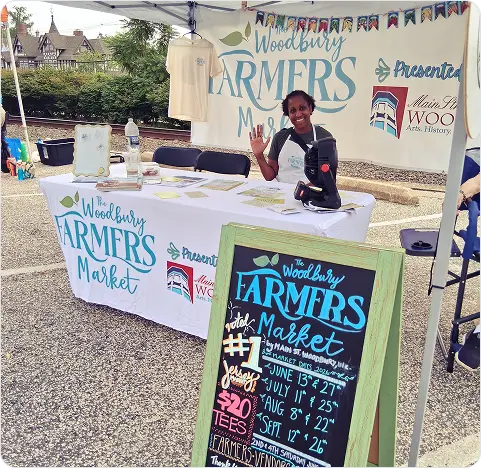 volunteer at woodbury framers merket tent Woodbury Farmers Market